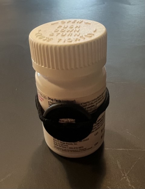 a pill bottle with a waytag attached