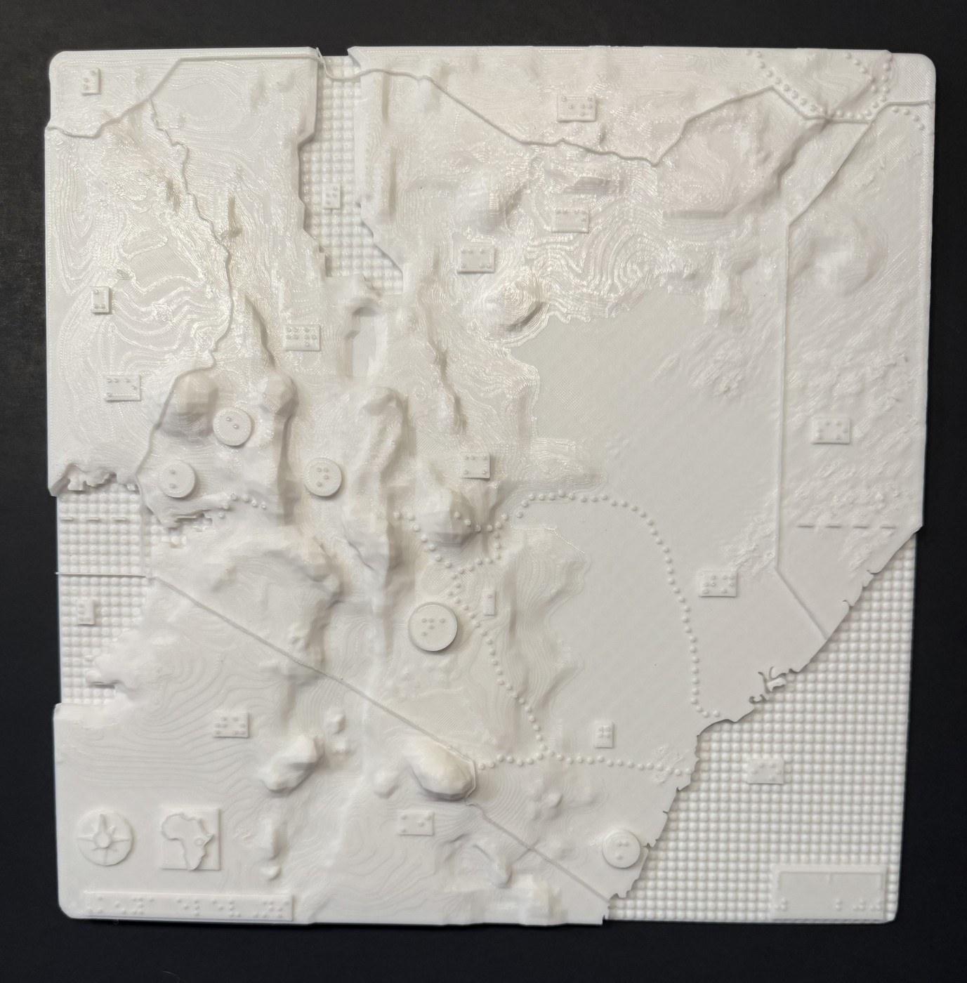 3D-printed tactile elevation map of Kenya with raised terrain and braille labels.